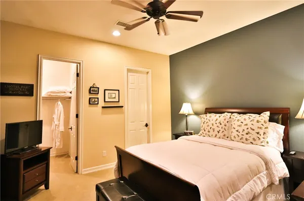 a bedroom with two beds and a chandelier