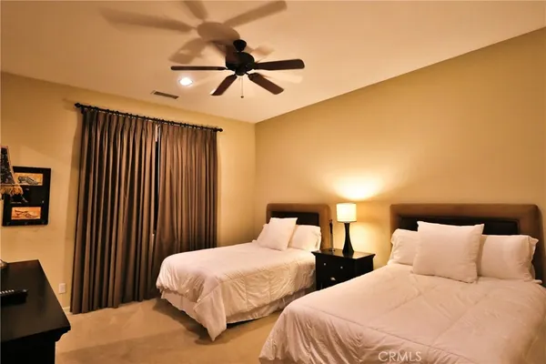 a living room with stainless steel appliances kitchen island granite countertop a sink and a granite counter tops with a large window