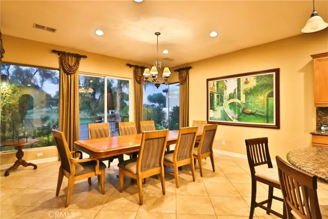 a view of a dining room with furniture large windows and wooden floor