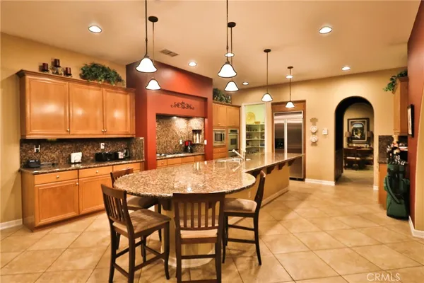 a large kitchen with a table and chairs