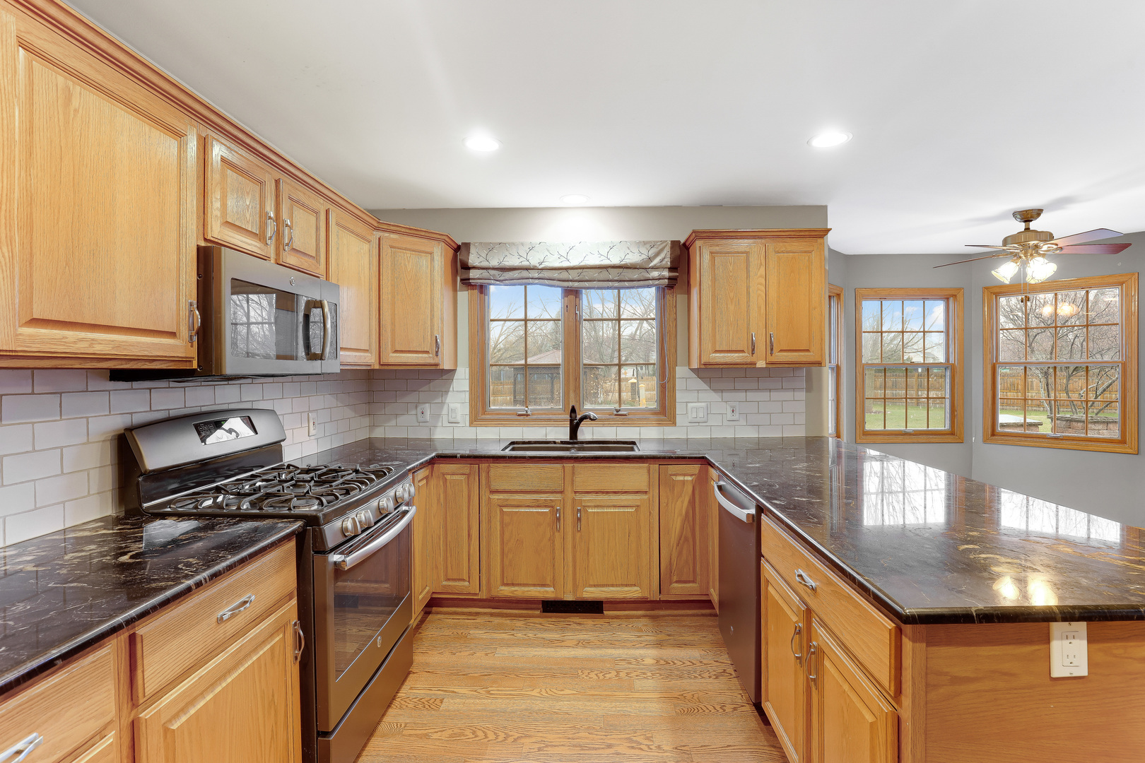 959 Willow Circle DeKalb, IL 60115 - Photo 14 of 39 a kitchen with stainless steel appliances granite countertop a sink stove and cabinets
