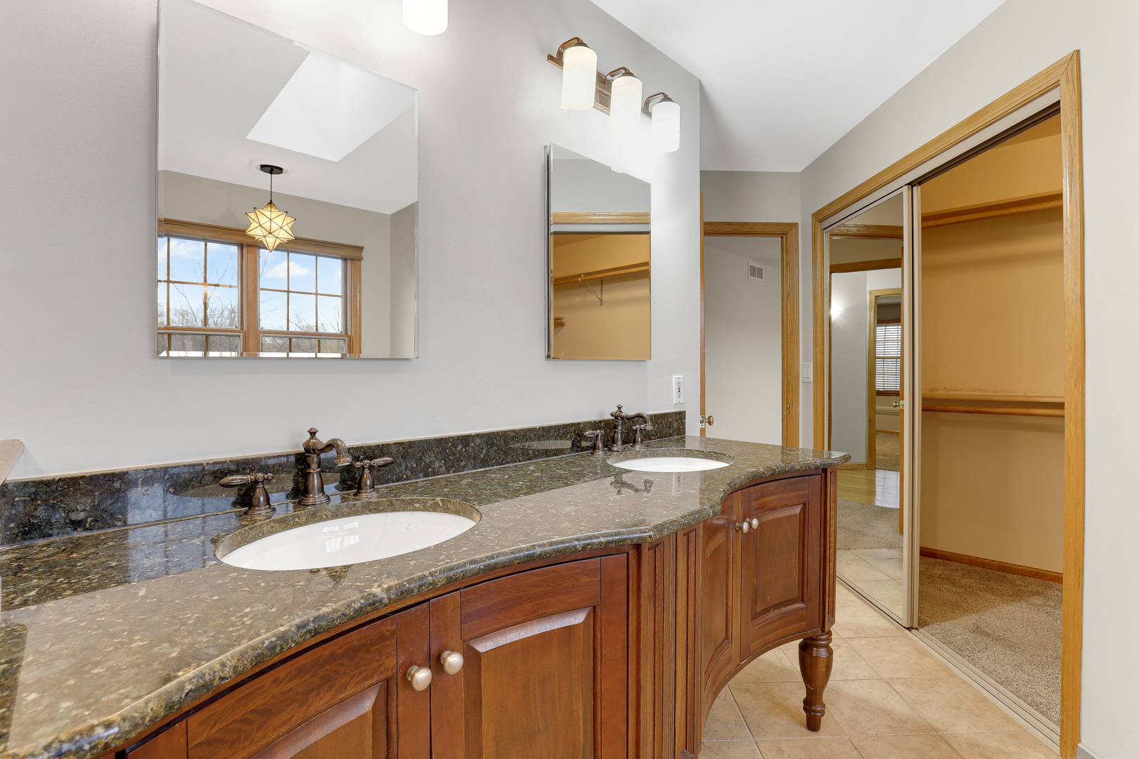 959 Willow Circle DeKalb, IL 60115 - Photo 29 of 39 a bathroom with a granite countertop sink and a mirror