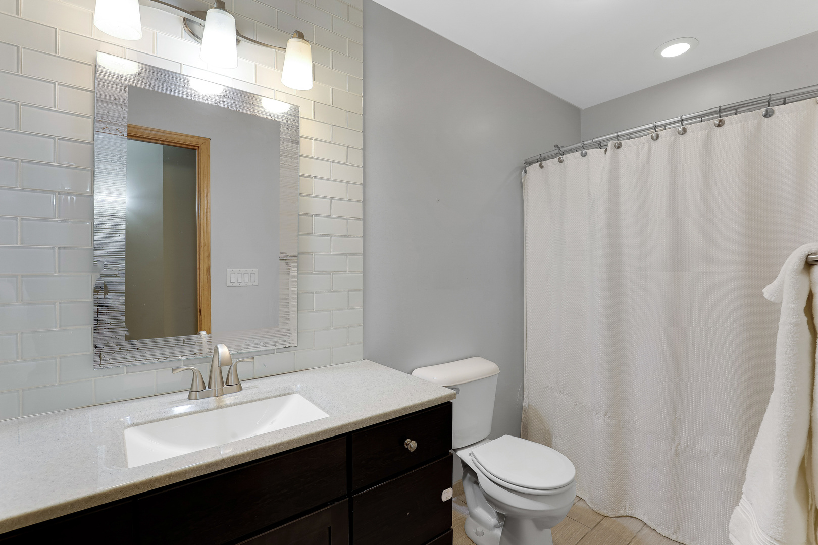959 Willow Circle DeKalb, IL 60115 - Photo 33 of 39 a bathroom with a sink a toilet a mirror and shower curtain