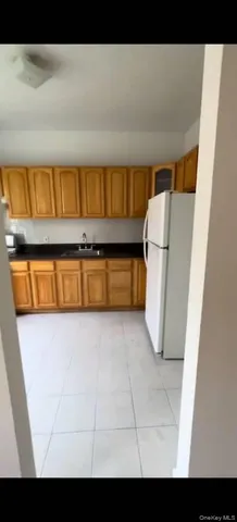a kitchen with a refrigerator and a table