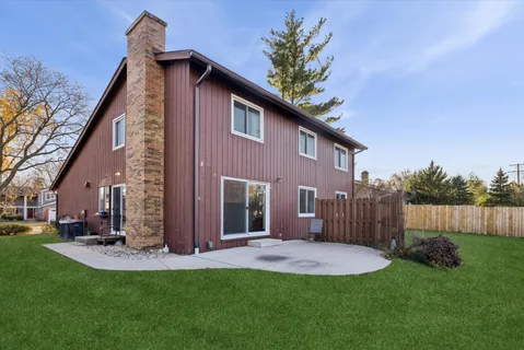 a view of a house with a yard and pathway