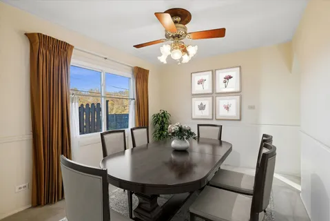 a view of a dining room with furniture and chandelier