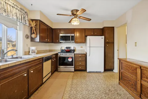 a kitchen with refrigerator cabinets and a sink