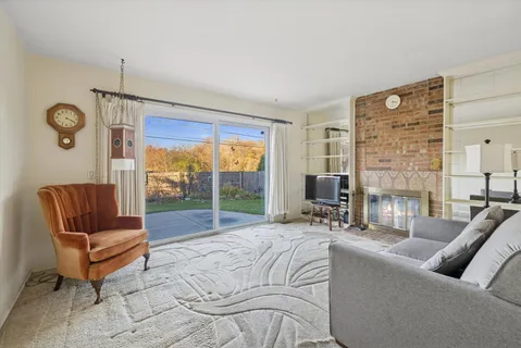 a living room with furniture and a floor to ceiling window