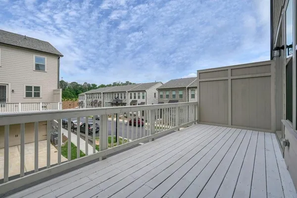 a view of balcony with wooden floor and fence