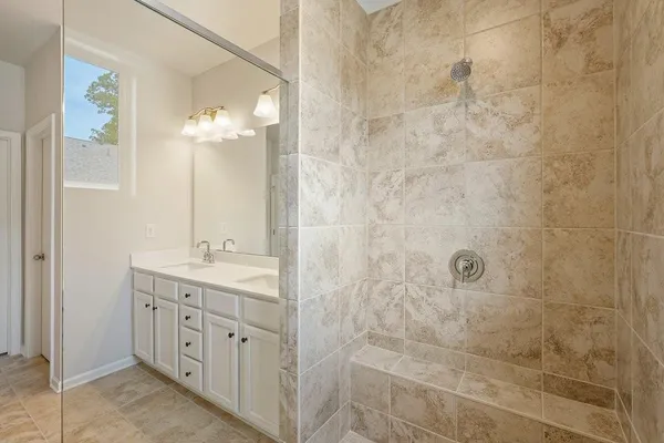 a bathroom with a double vanity sink a toilet and a shower