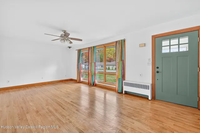 wooden floor in an empty room with a window