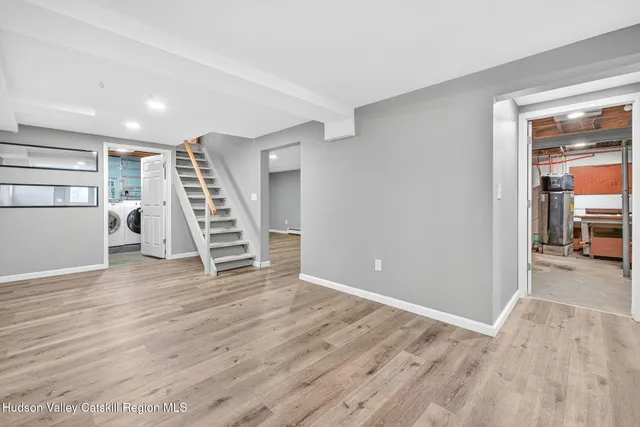 a view of a room with wooden floor and stairs