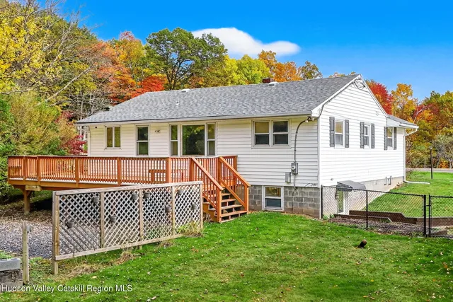 a view of a house with a backyard