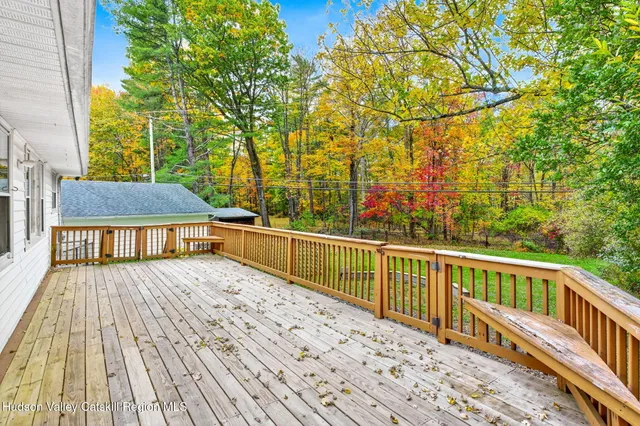 a view of balcony with wooden floor and fence