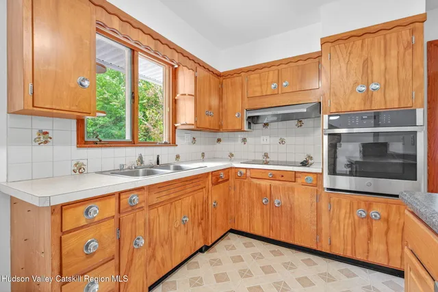 a kitchen with a sink stove and cabinets