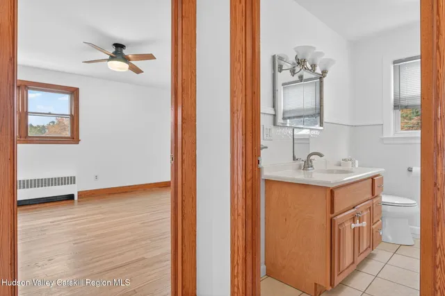 a bathroom with a sink a toilet and mirror