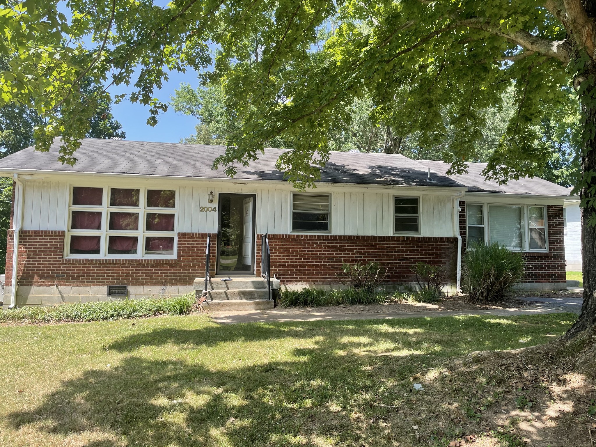2004 Post Road Clarksville, TN 37043 - Photo 1 of 16 a front view of a house with a garden and yard