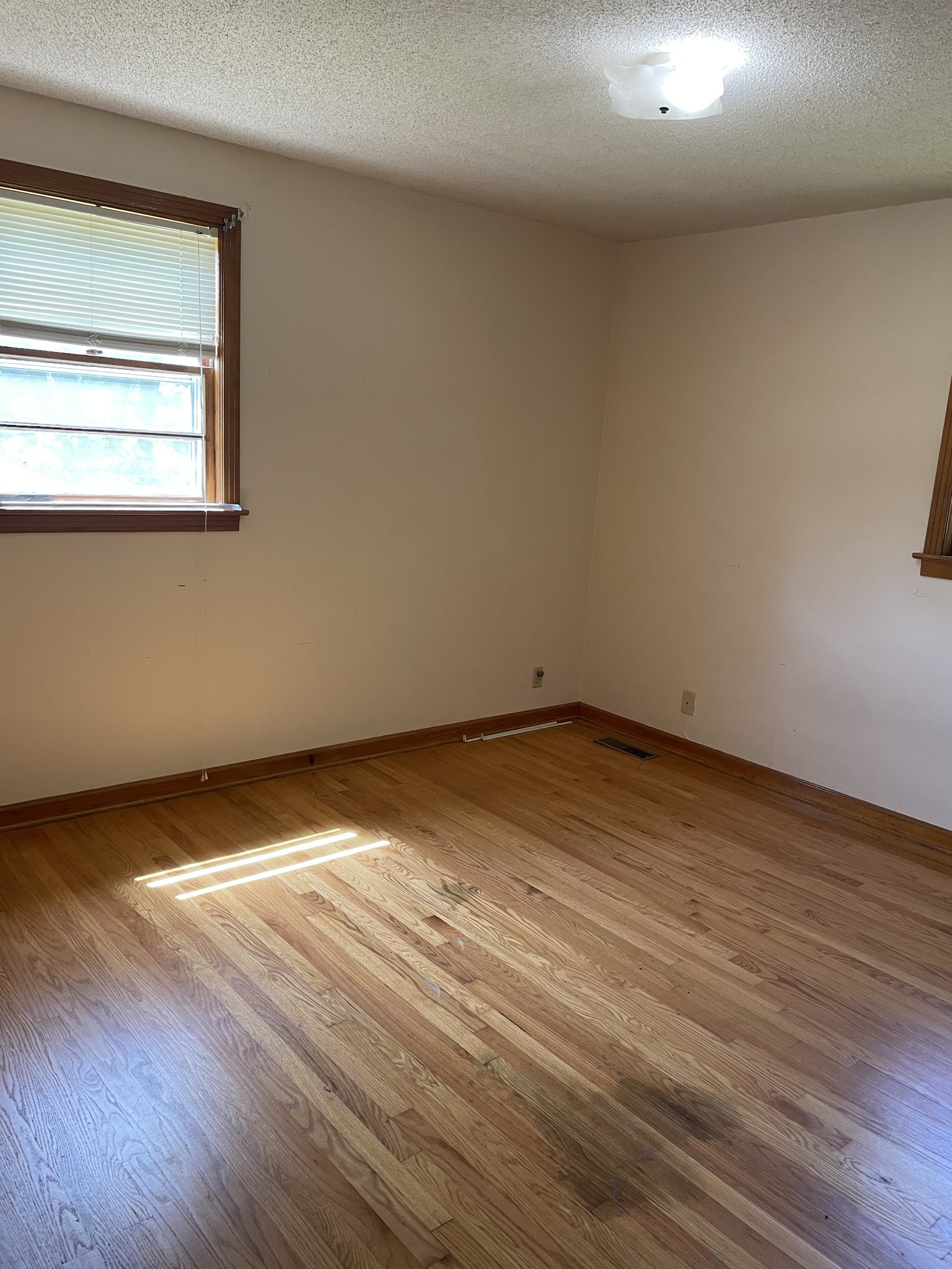 2004 Post Road Clarksville, TN 37043 - Photo 13 of 16 an empty room with wooden floor and windows
