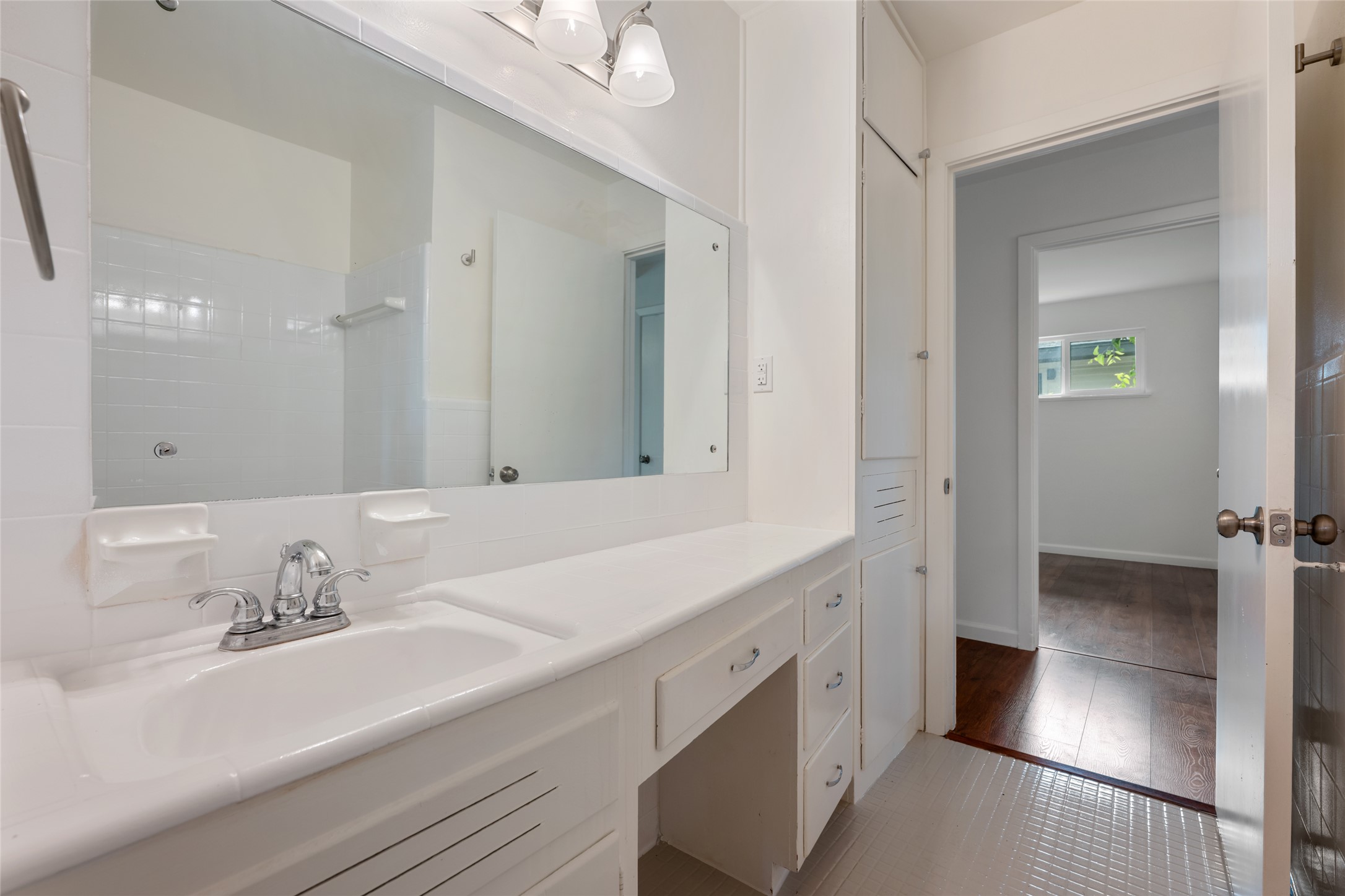 4602 Frontier Trail Austin, TX 78745 - Photo 15 of 21 A pristine vanity area, offering extensive counter space and built-in storage solutions.