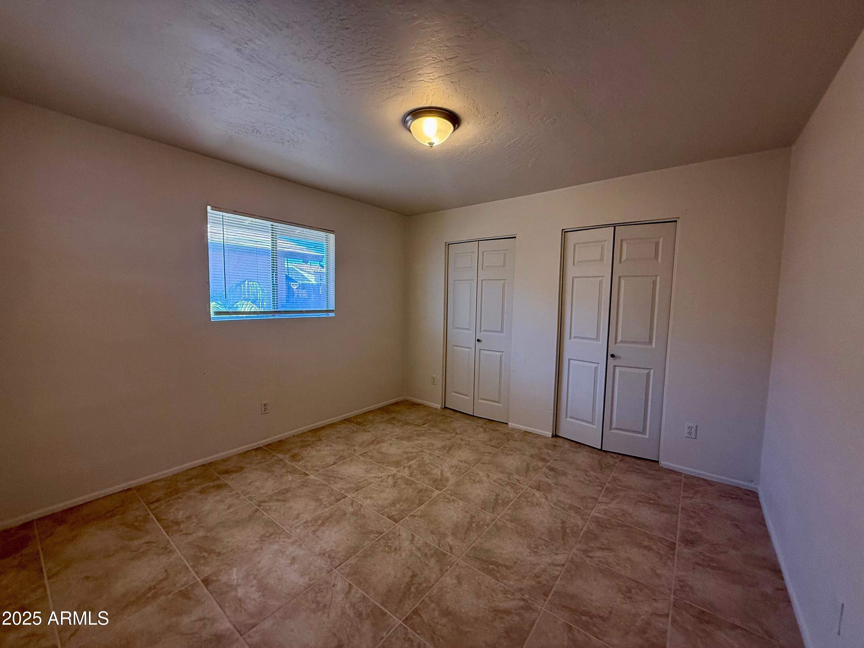 28 West Elm Street Tucson, AZ 85705 - Photo 12 of 14 a view of an empty room with a window