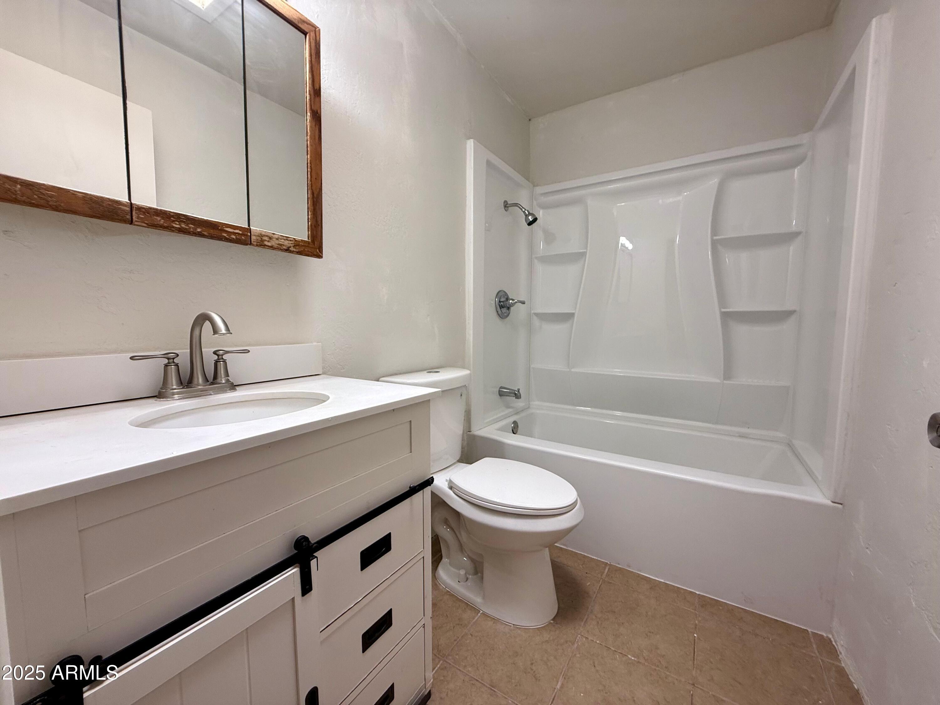 28 West Elm Street Tucson, AZ 85705 - Photo 3 of 14 a bathroom with a sink a toilet and bathtub