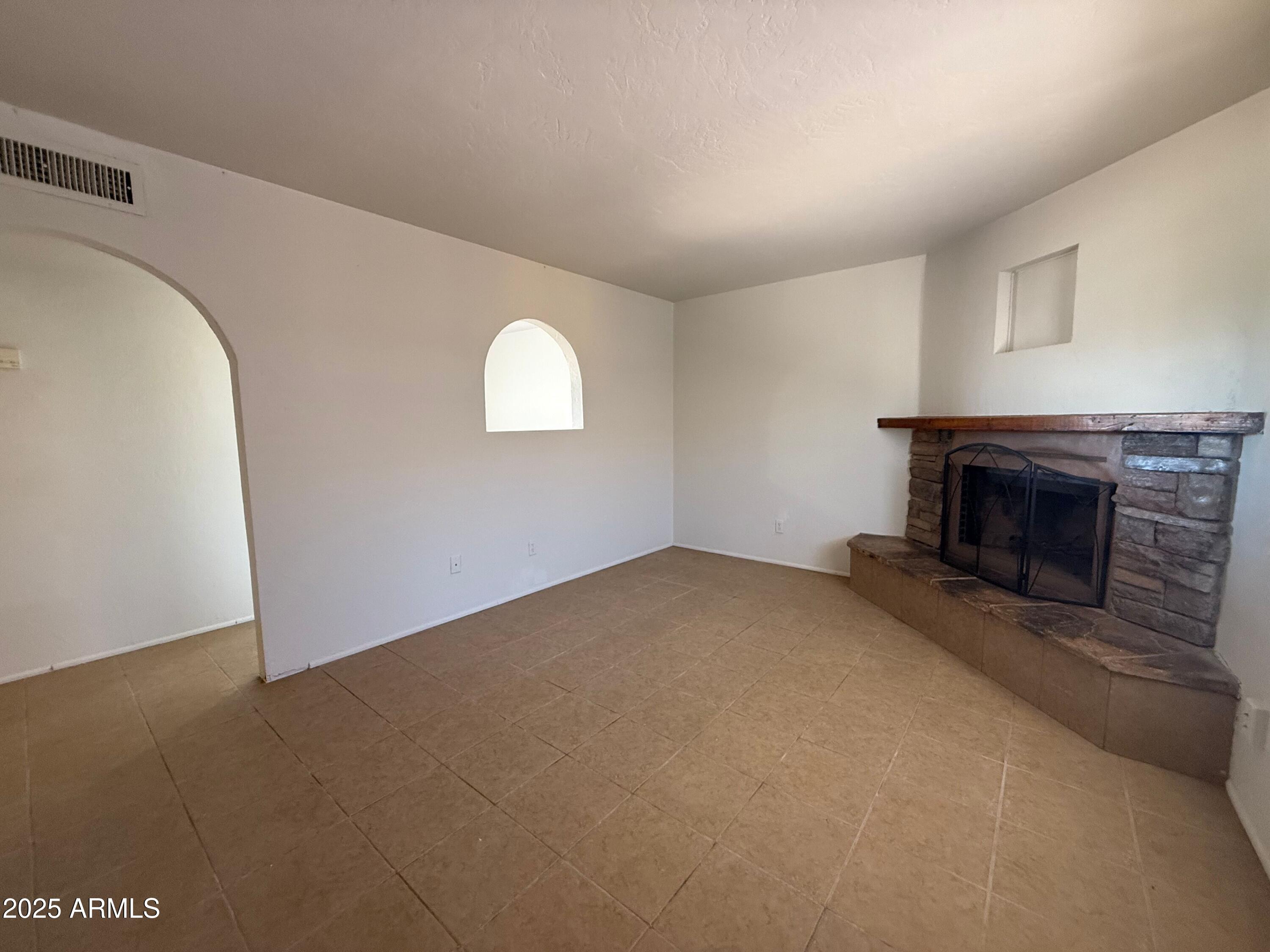 28 West Elm Street Tucson, AZ 85705 - Photo 5 of 14 a view of empty room with a fireplace