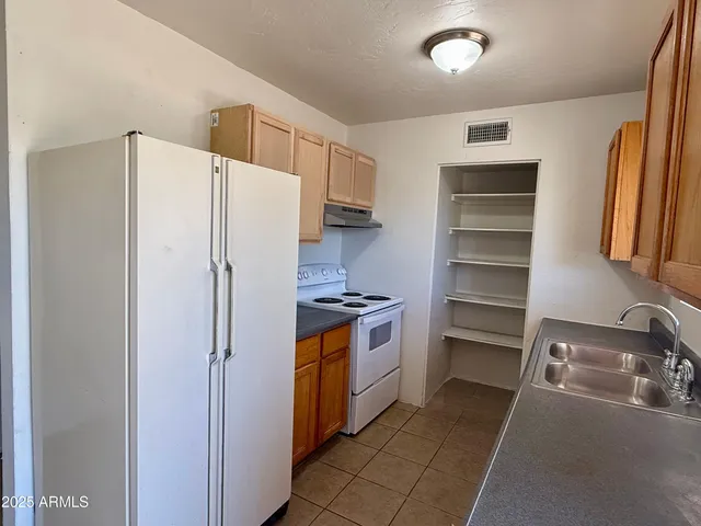 a kitchen with stainless steel appliances granite countertop a sink and a cabinets