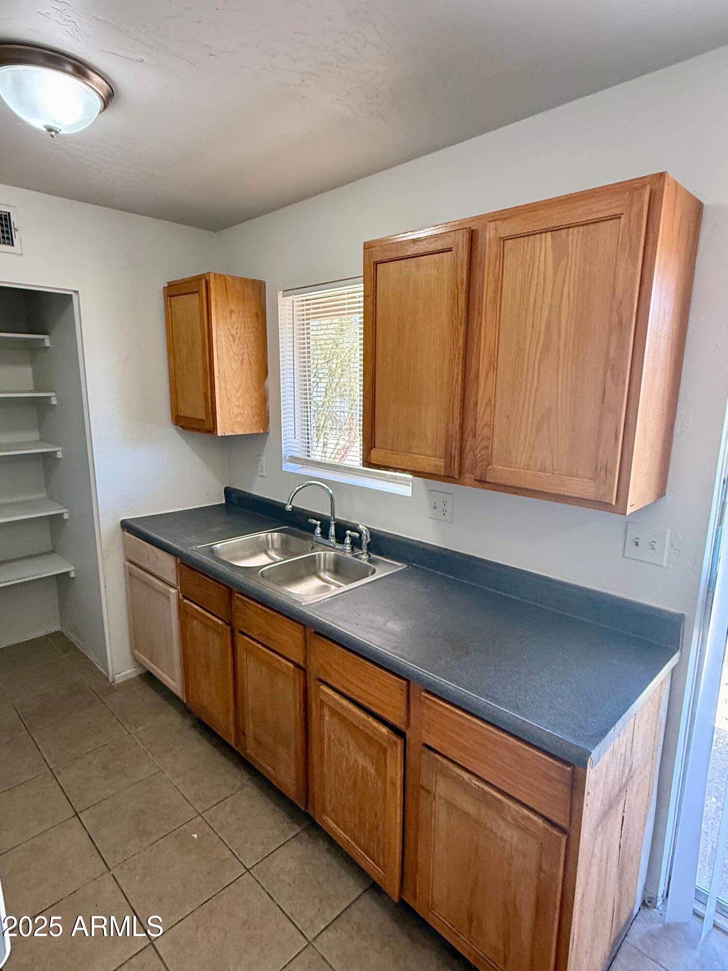 28 West Elm Street Tucson, AZ 85705 - Photo 8 of 14 a kitchen with stainless steel appliances granite countertop a sink and a cabinets