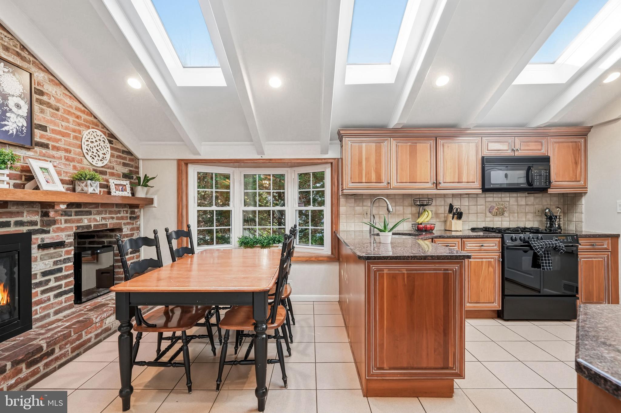 217 Red Stone Ridge Cherry Hill, NJ 08034 - Photo 15 of 44 a kitchen with stainless steel appliances granite countertop a stove top oven a sink dishwasher a dining table and chairs with wooden floor