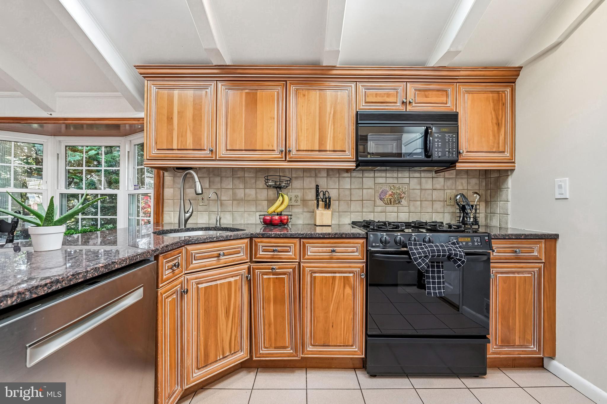 217 Red Stone Ridge Cherry Hill, NJ 08034 - Photo 17 of 44 a kitchen with stainless steel appliances granite countertop a stove a sink and a microwave
