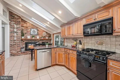 a kitchen with stainless steel appliances granite countertop a sink and cabinets