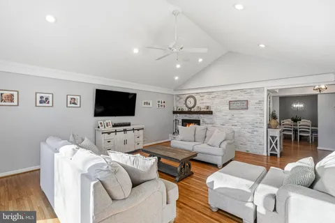 a living room with a fireplace and a clock