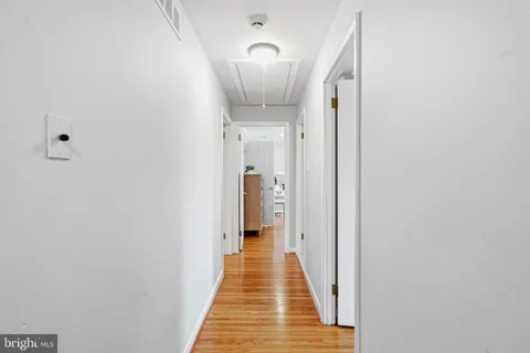 a bedroom with bed and wooden floor