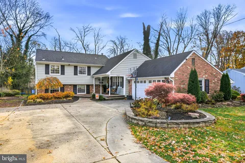 a view of a house with a chairs in a patio