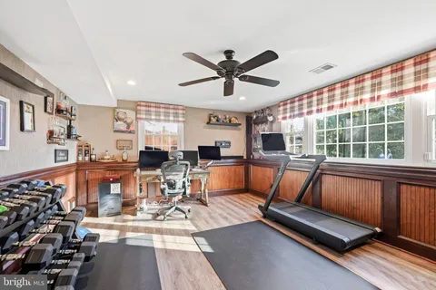a view of a rooftop deck with couch and chairs