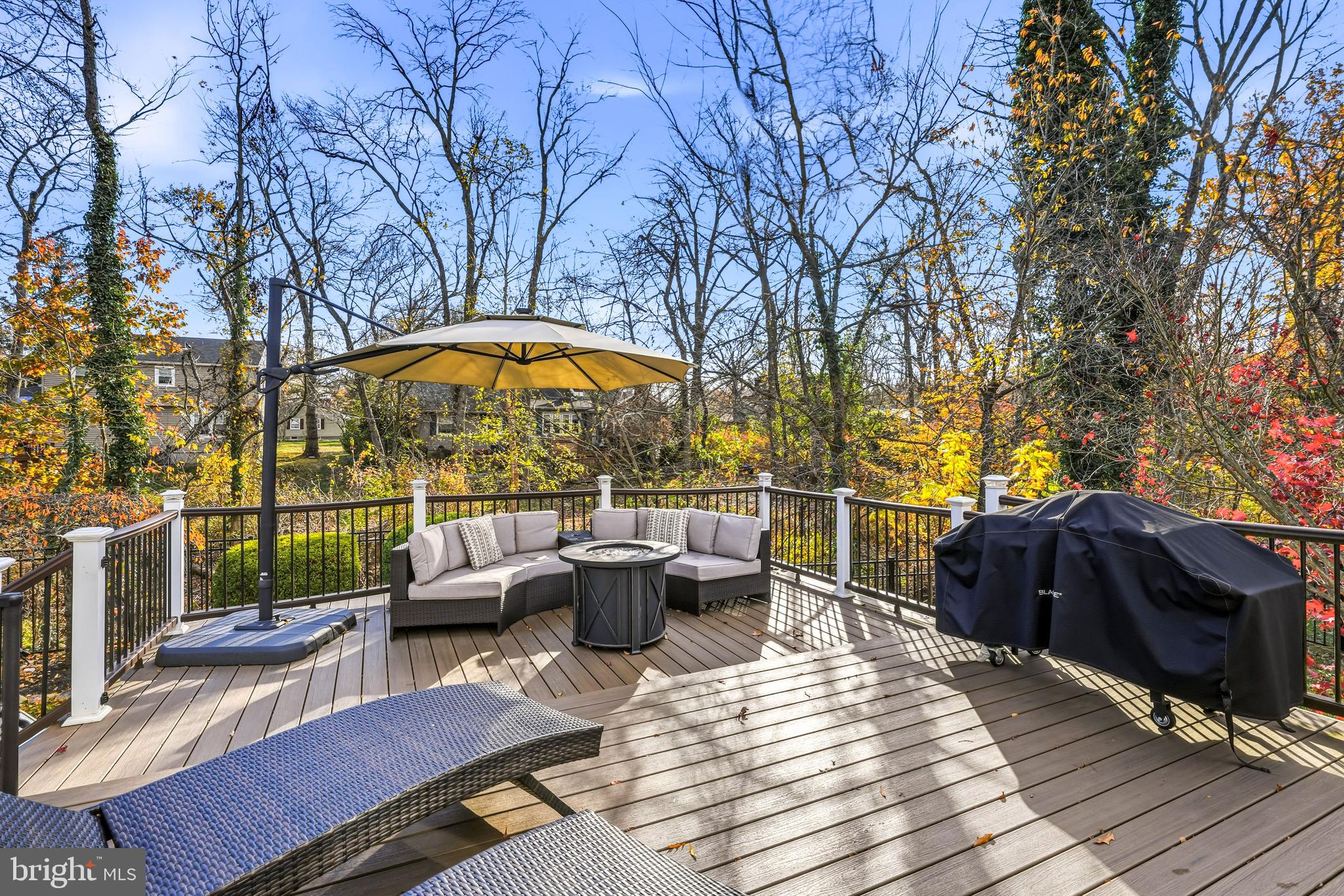 217 Red Stone Ridge Cherry Hill, NJ 08034 - Photo 40 of 44 a view of a patio with couches table and chairs under an umbrella with wooden floor