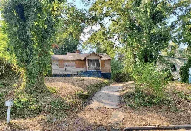 a front view of a house with a garden
