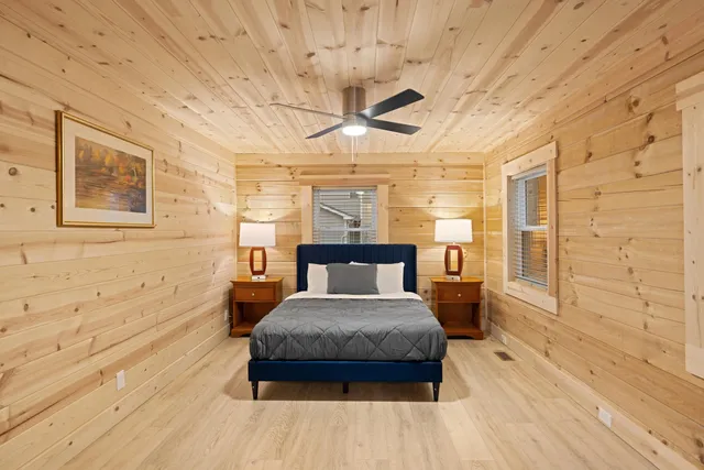 a bedroom with a bed and a mirror on the dresser