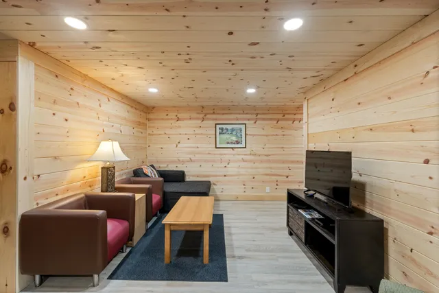 a living room with furniture wooden floor and a flat screen tv