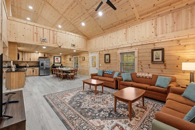 a living room with furniture kitchen view and a table