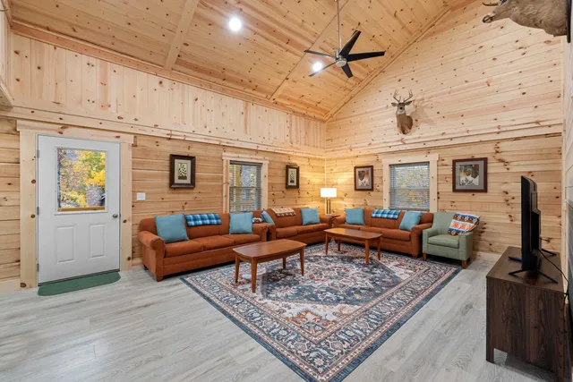 a living room with furniture rug and wooden floor