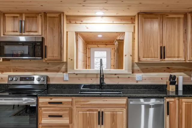 a kitchen with granite countertop a sink and a stove