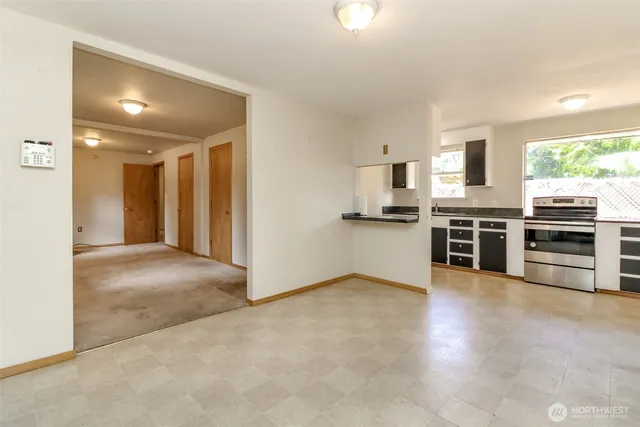 a view of a kitchen with a stove wooden cabinets and a refrigerator
