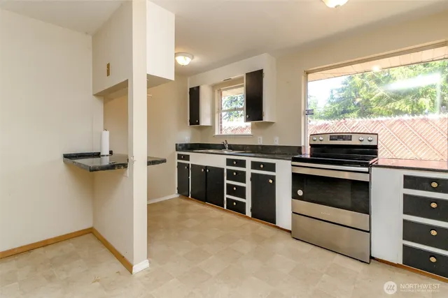 a kitchen with a stove and a refrigerator