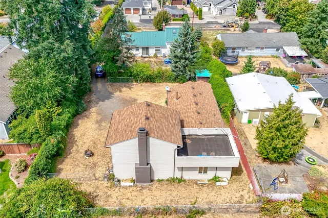 an aerial view of a house with a yard and trees