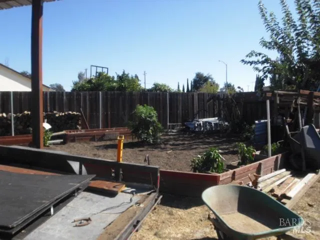 a view of a backyard with couches chair and tables