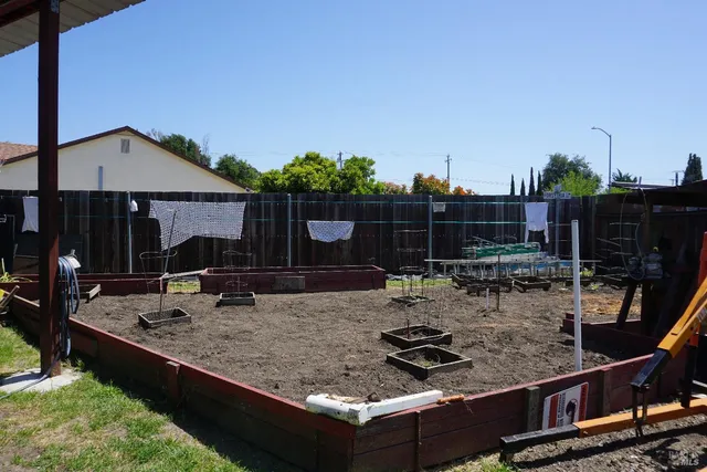 a view of a backyard with sitting area