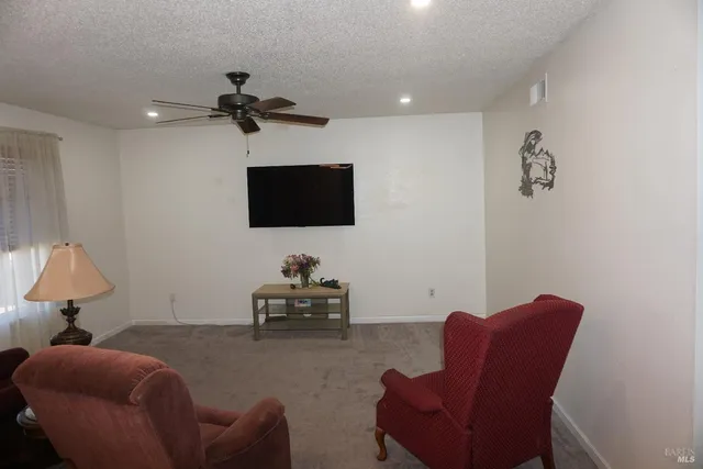 a living room with furniture a couch and a flat screen tv