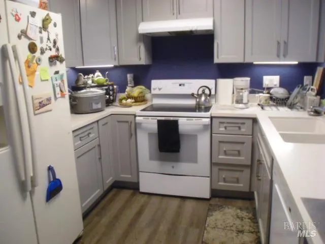 a kitchen with stainless steel appliances granite countertop a sink and a stove