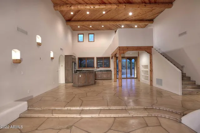 a view of a livingroom with a fireplace and window